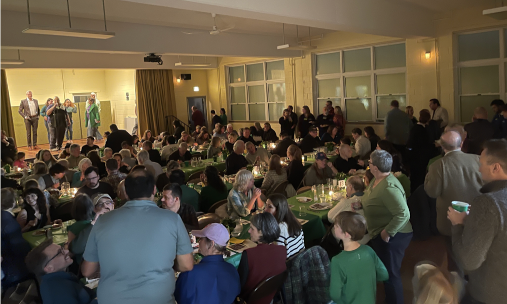People eating at the corned beef and cabbage 
dinner
